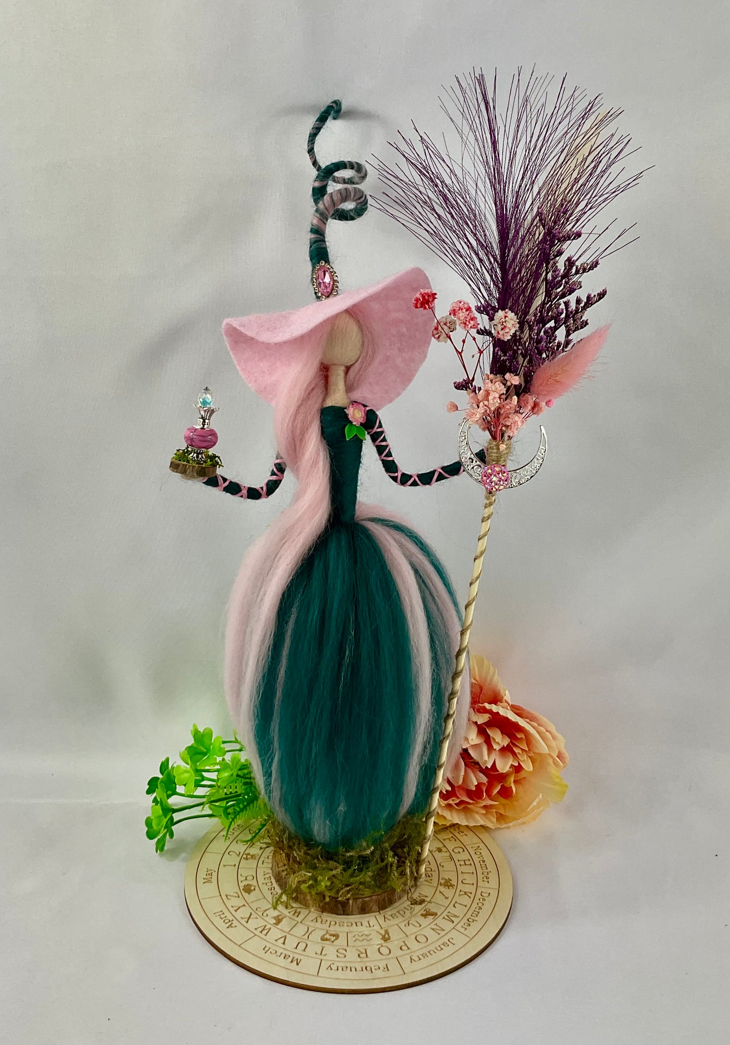 Pink and teal witch with display disk