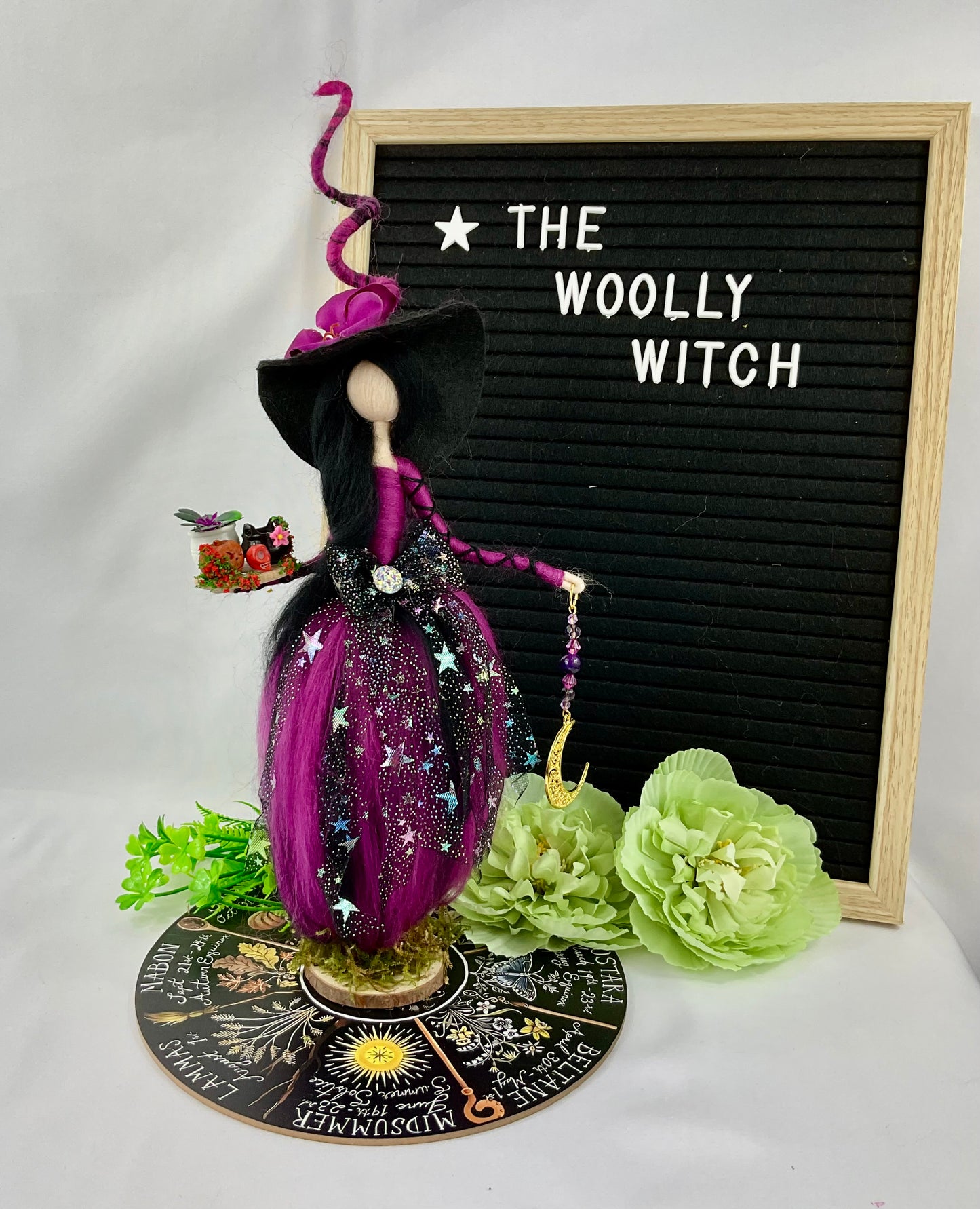 Purple and black witch on a display disk