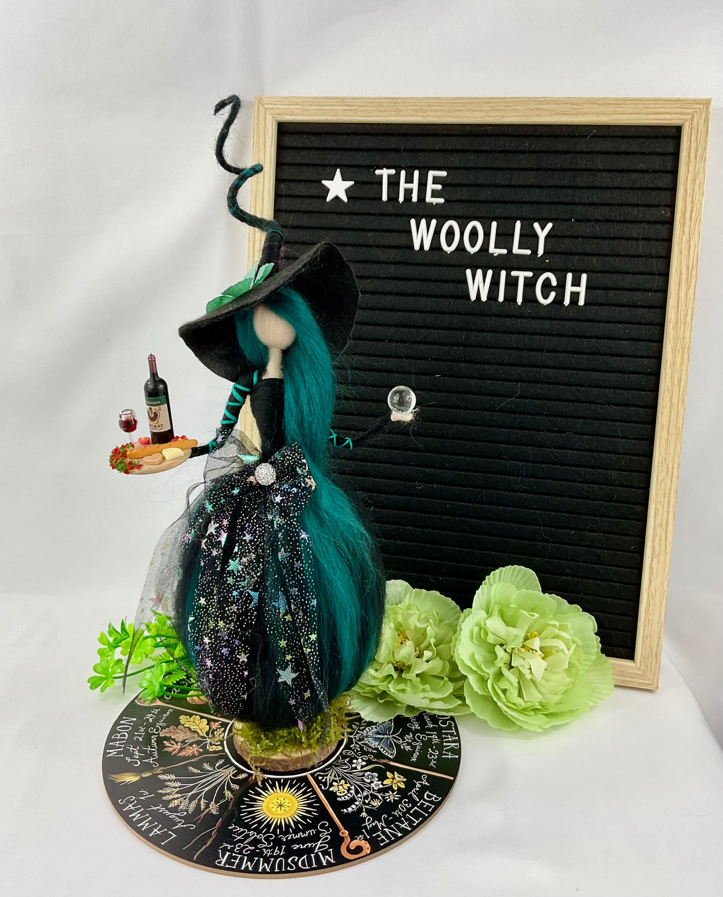 Teal and black witch with display disk