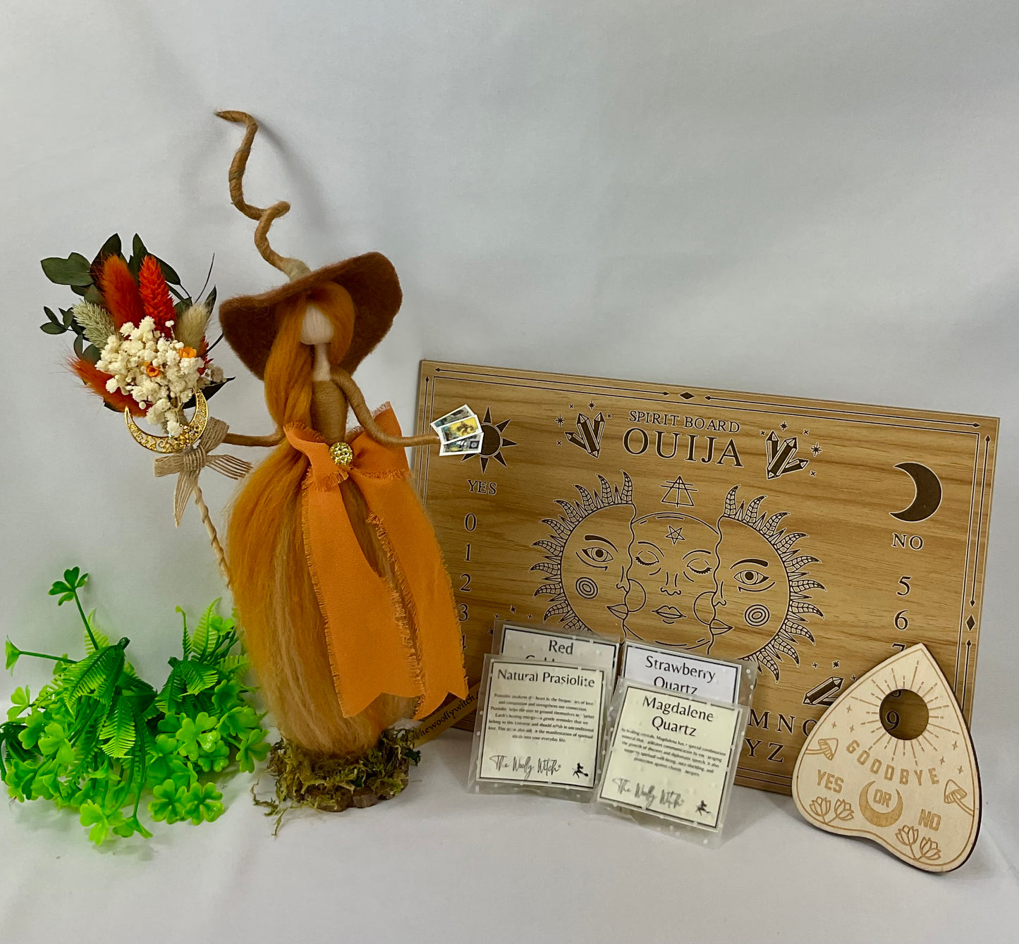 Orange witch with ouija board display and tumble stones