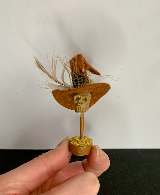 Steampunk miniature skull hat stand.