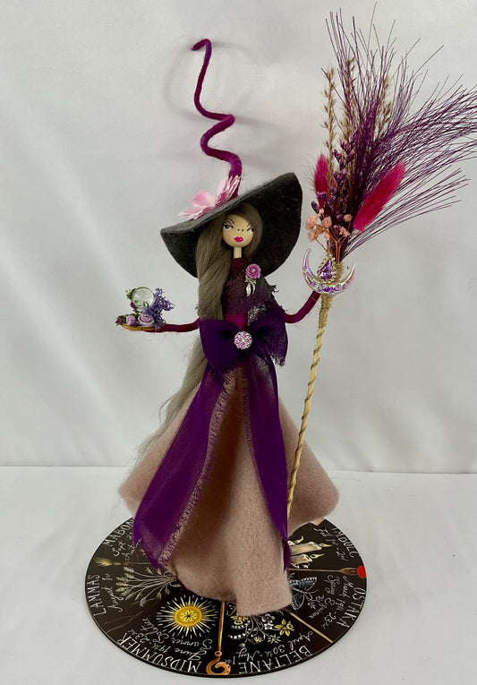 Purple witch with display board.