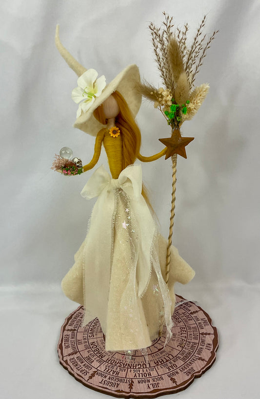 Cream and mustard coloured witch with a floral broom and a mini red jasper altar