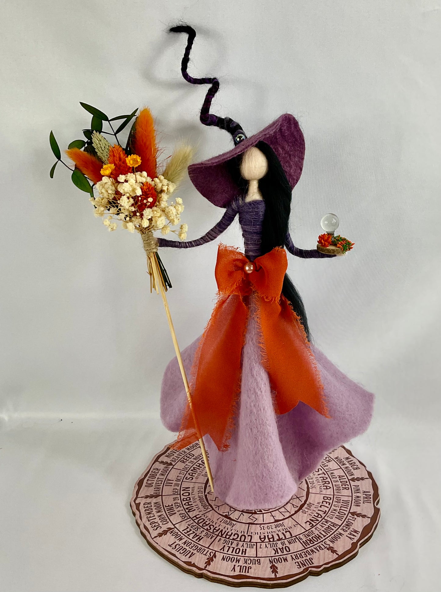 Orange and purple witch with bouquet broom