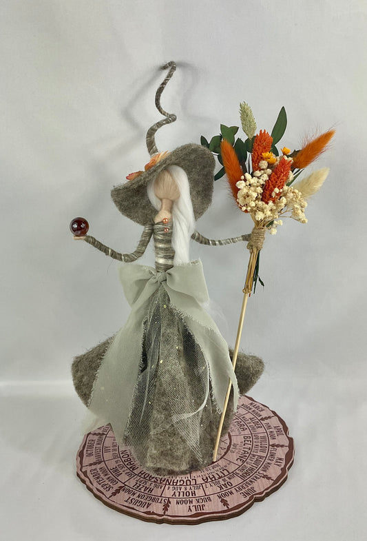 Crone with orange bouquet broom