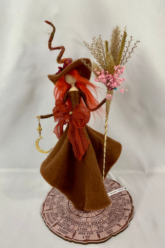 Brown witch with floral broom