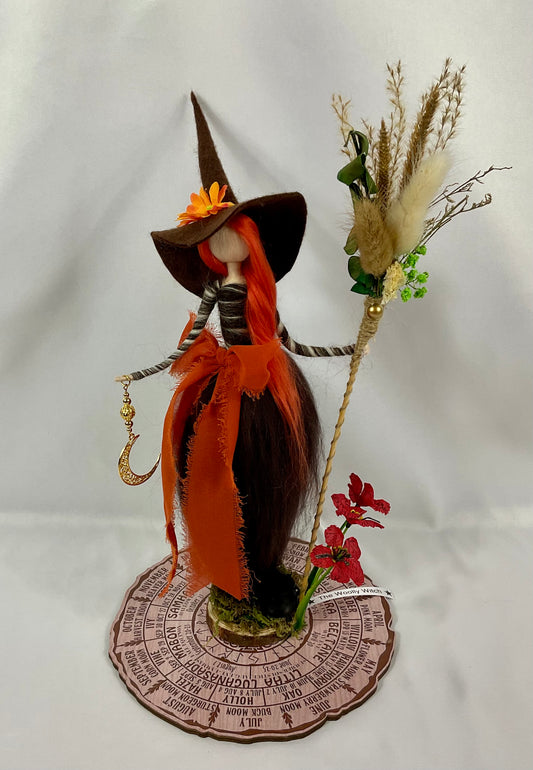 Brown witch with floral broom and mini cauldron