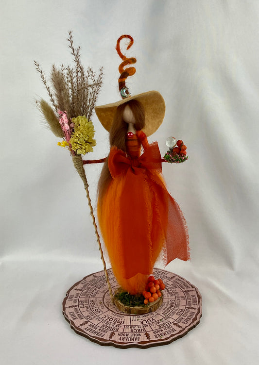 Orange witch with floral broom