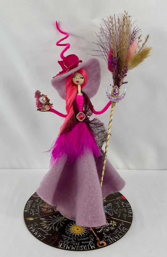 Hot pink and purple witch with display disk
