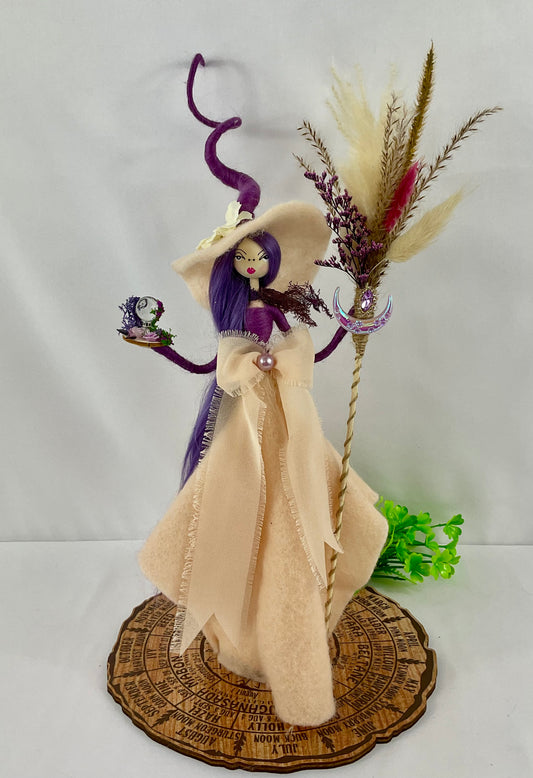 Peachy and purple witch with display board
