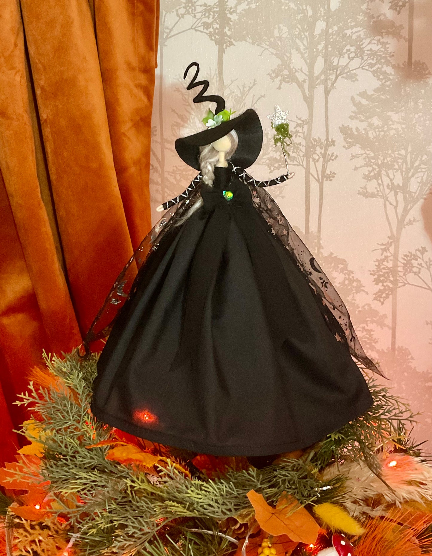 Black witch with star and moon cape.