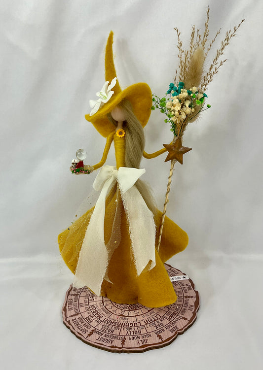 Mustard witch with a floral broom and a mini red jasper altar